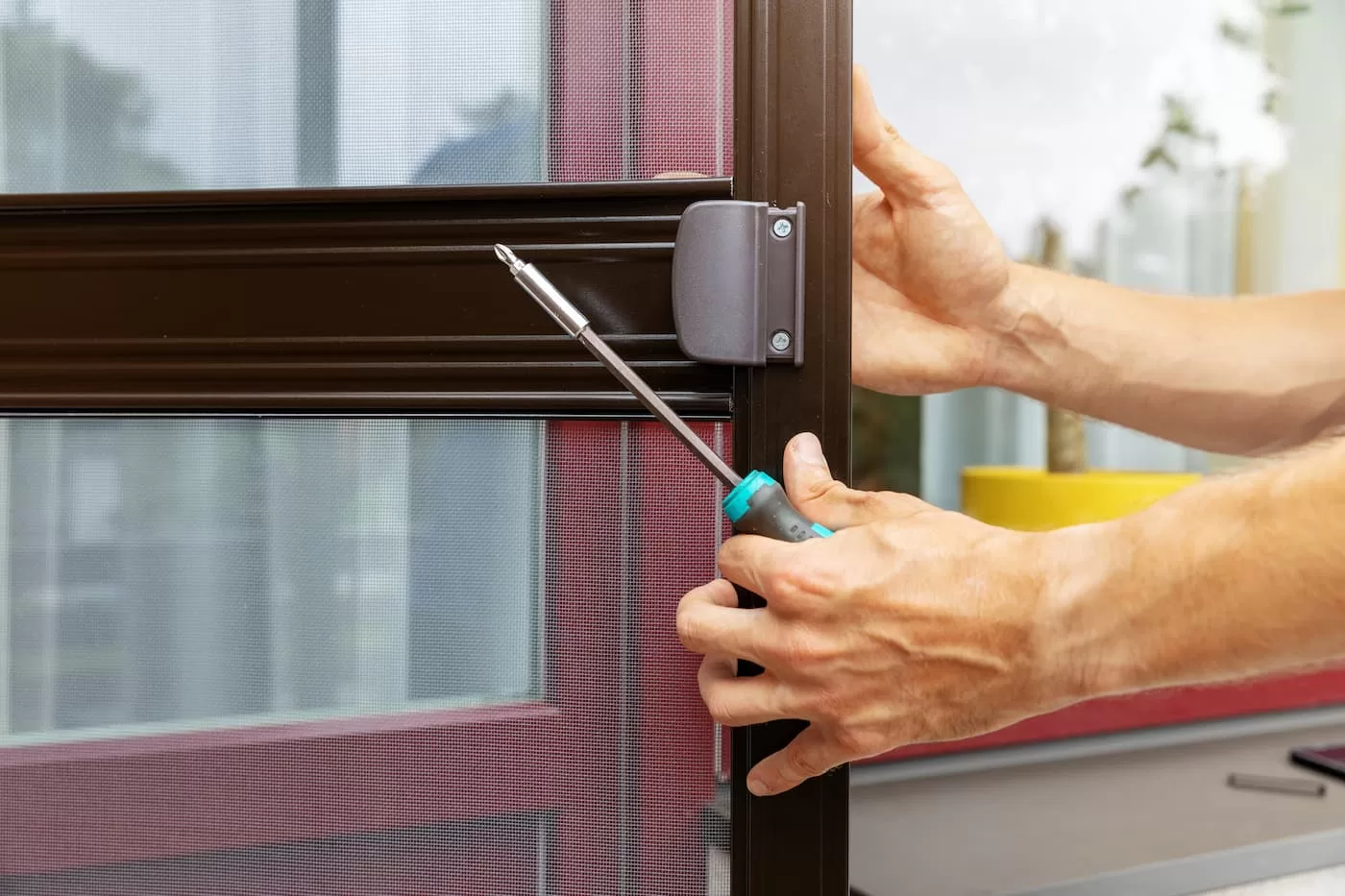 Technician installing a new screen door in Toronto